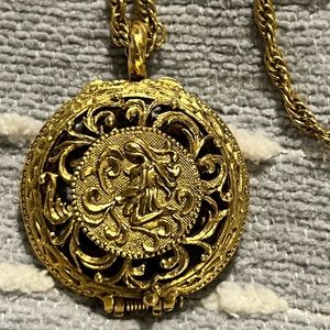 Gold necklace with hinged cage with lady. 14” drop. Diffuser for oils.